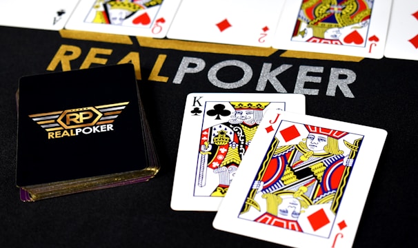 A vibrant rummy game interface showing cards and player scores with bright gradient backgrounds.